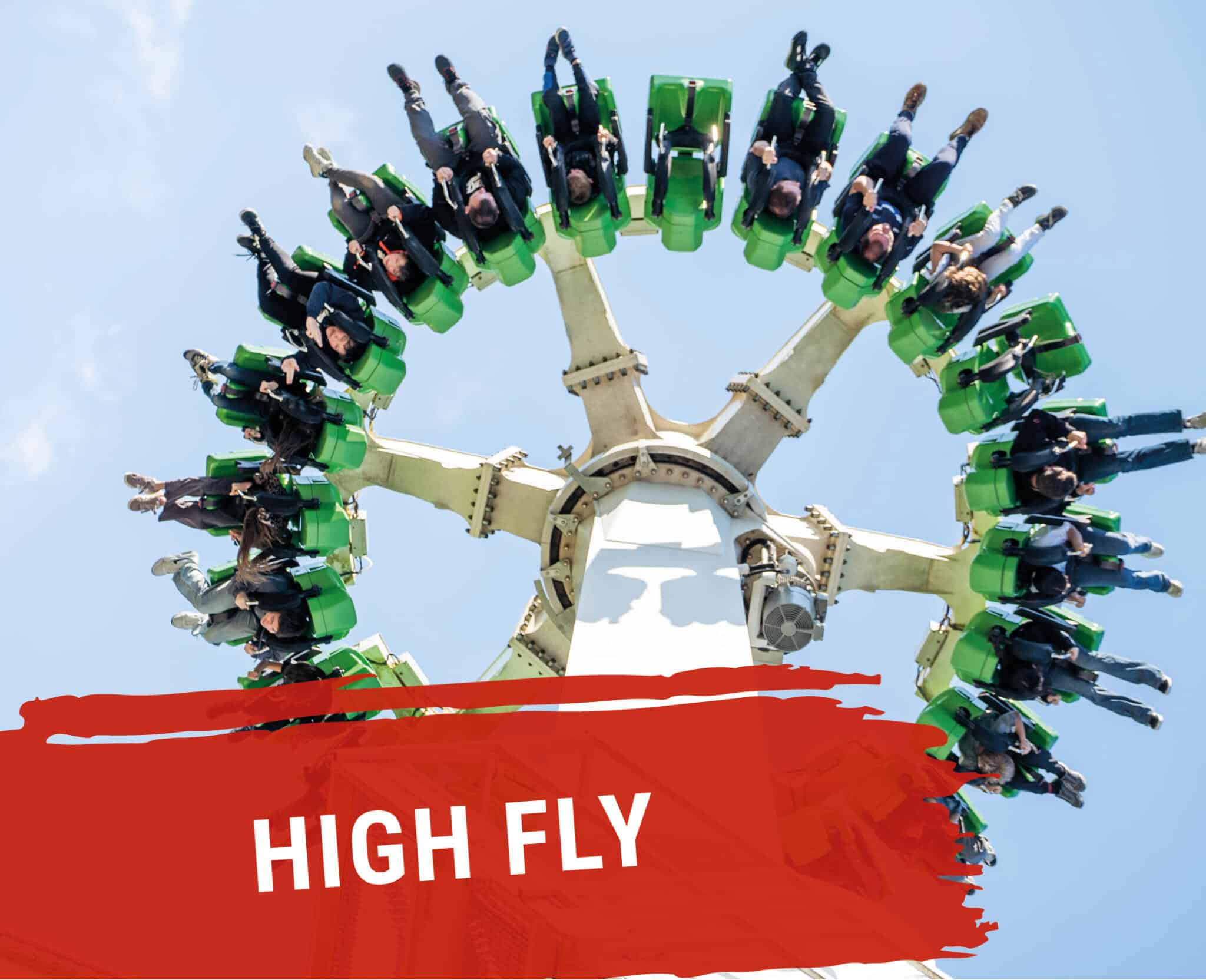 High Fly – Fahrgeschäft mit rotierenden grünen Gondeln, Fahrgäste hängen kopfüber in der Luft