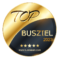 Goldene Auszeichnung mit der Aufschrift 'TOP BUSZIEL 2023' und fünf Sternen.